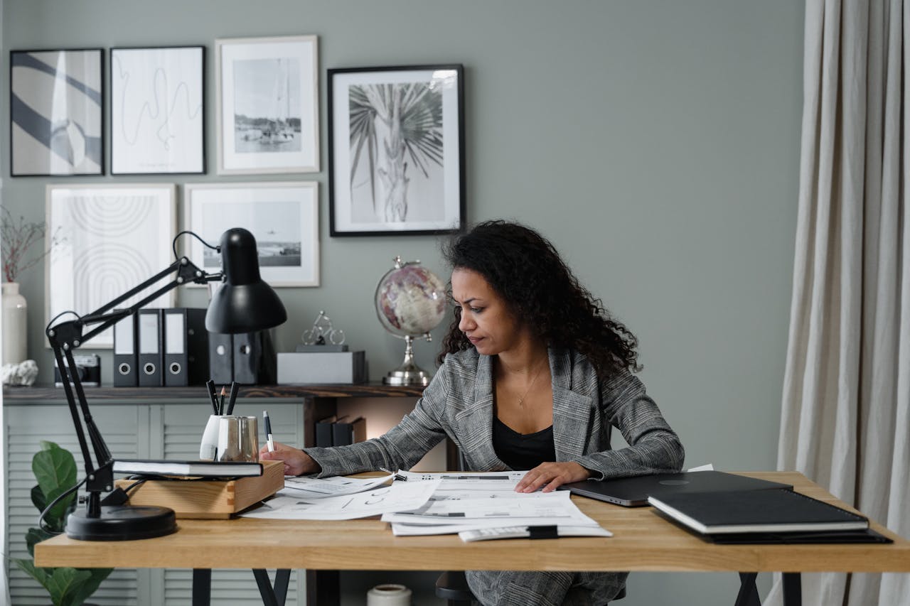 The Art of Drawing Readers In: Your attractive post title goes here Businesswoman evaluates documents at a modern desk in a stylish office setting.